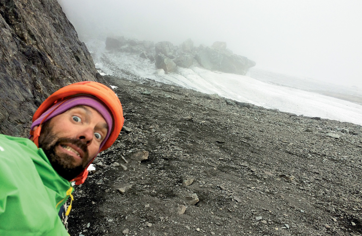 Patrick Guillaume, alarmed by the state of the Glacier Carre in October 2018. The normally snowy glacier was covered in rocks and had melted down to the ice, while countless massive blocks lingered on the face and above it. [Photo] Olivier Laborie
