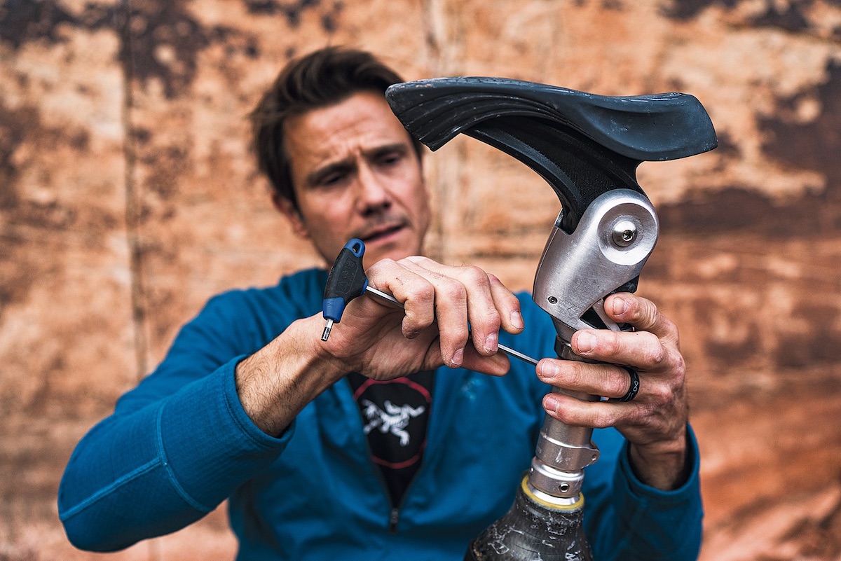 DeMartino adjusts his prosthetic foot between climbs. The angle [of the foot] can be changed by a series of set screws that allow me to alter the way it interacts with a crack, he says. [Photo] Angela Percivall