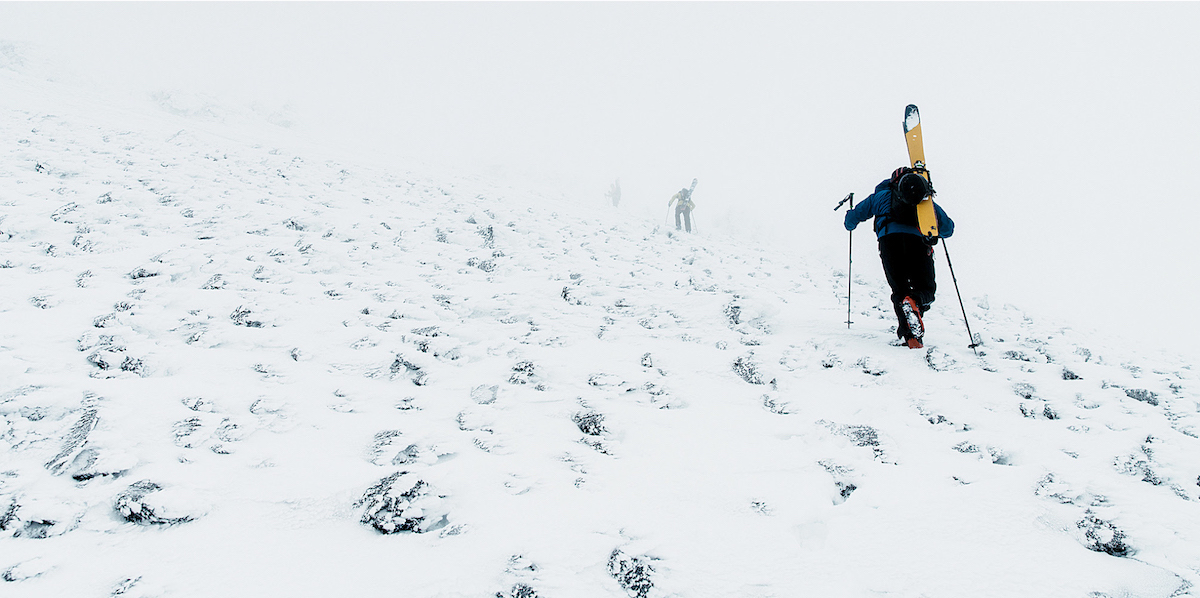 Forrest Shearer, Connor Ryan and Len Necefer disappear into the blowing snow and clouds above the tree line on Dook'o'oosliid. [Photo] Greg Balkin