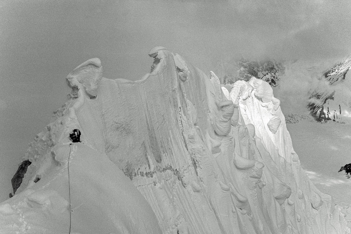 George Lowe, during the 1977 first ascent of the Lowe-Kennedy Route on the north face of Mt. Hunter (Begguya, 14,573'), Alaska Range. On an earlier attempt, Jeff Lowe fell near the sun-shadow line. [Photo] Michael Kennedy