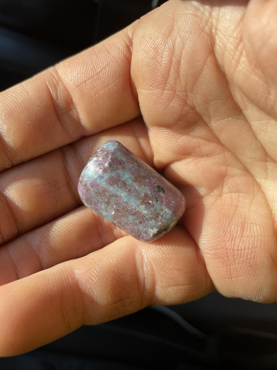 Derek Franz holds the ruby kyanite dream stone, which his neighbors gave him to take on his spring 2021 trip to Yosemite. [Photo] Derek Franz