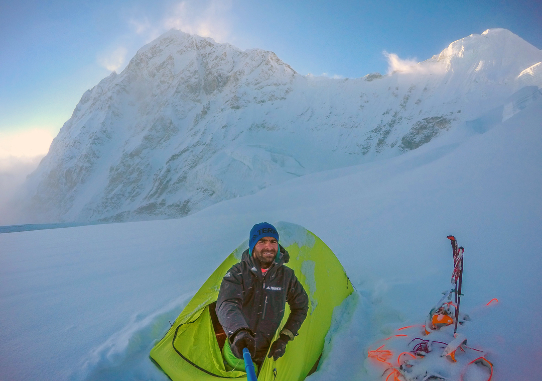 The 5800-meter camp on the southwest face of Shalbachum, which French climbers Julien Dusserre and Antoine Girard reached by paraglider. A storm forced them to retreat to this spot from 6200 meters, one day after landing. Dragpoche (aka Yansa Tsenji, 6567m) is behind. [Photo] Dusserre/Girard Collection