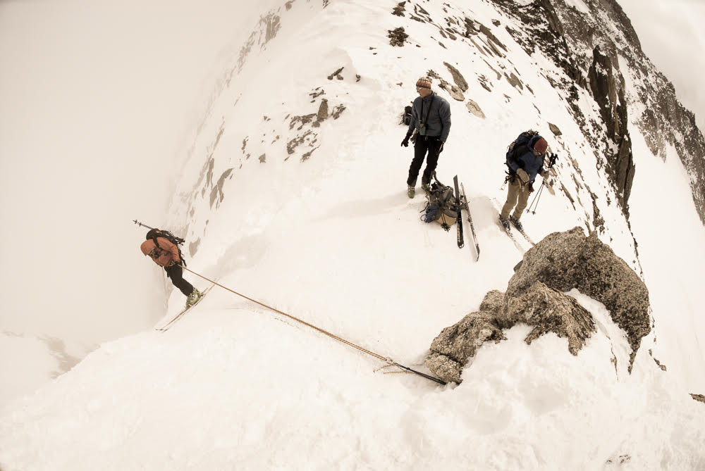 Adam Howard rappelling into the clouds at the Col du Chardonnet in Chamonix, France, in 2008 as Gordy Skoog looks on. [Photo] Jeff Diener