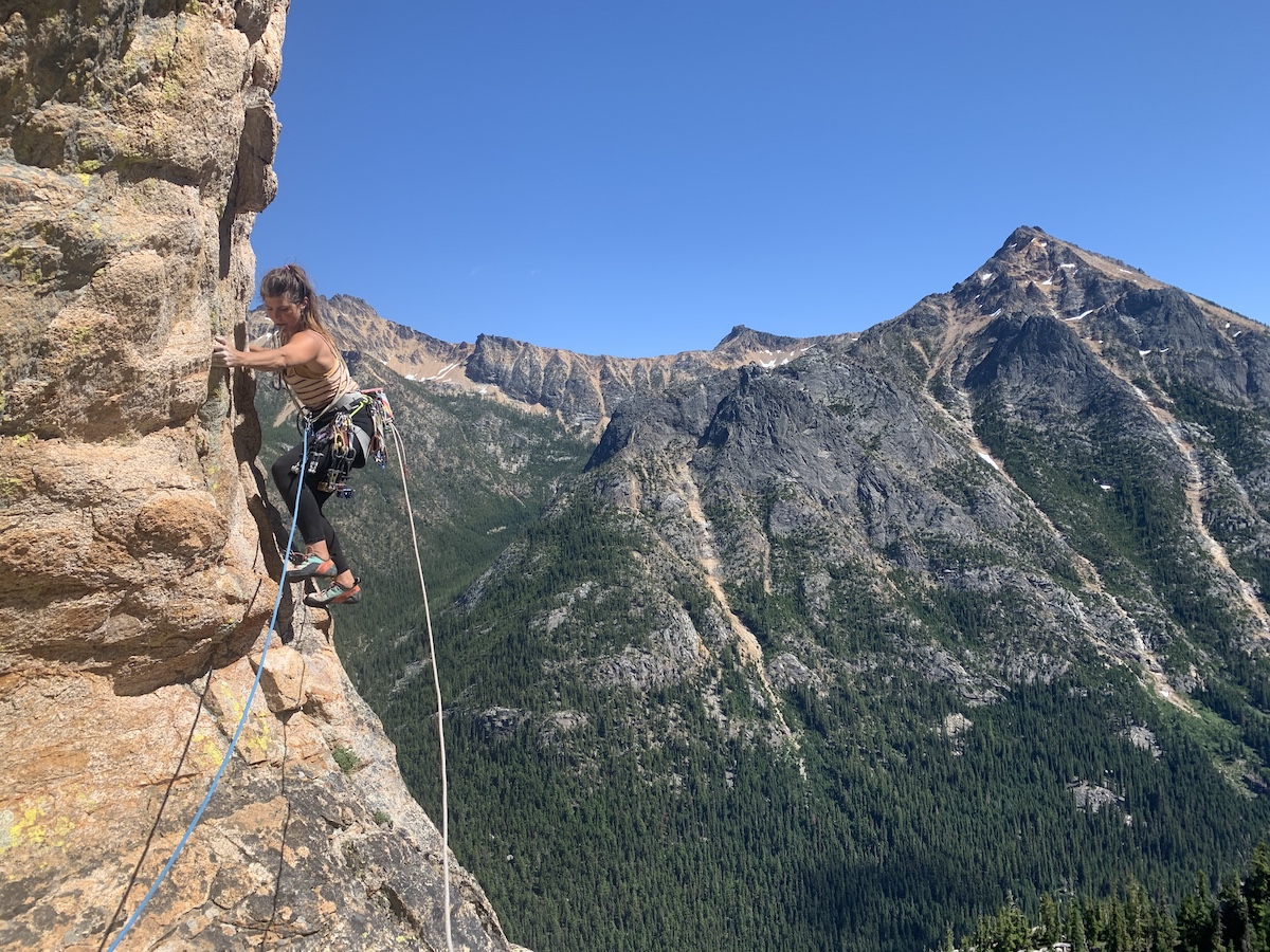 Whitney Clark traversing out from one of the supercaves while climbing The Tiger on Washington Pass with the Beal Opera rope. [Photo] Will Stanhope