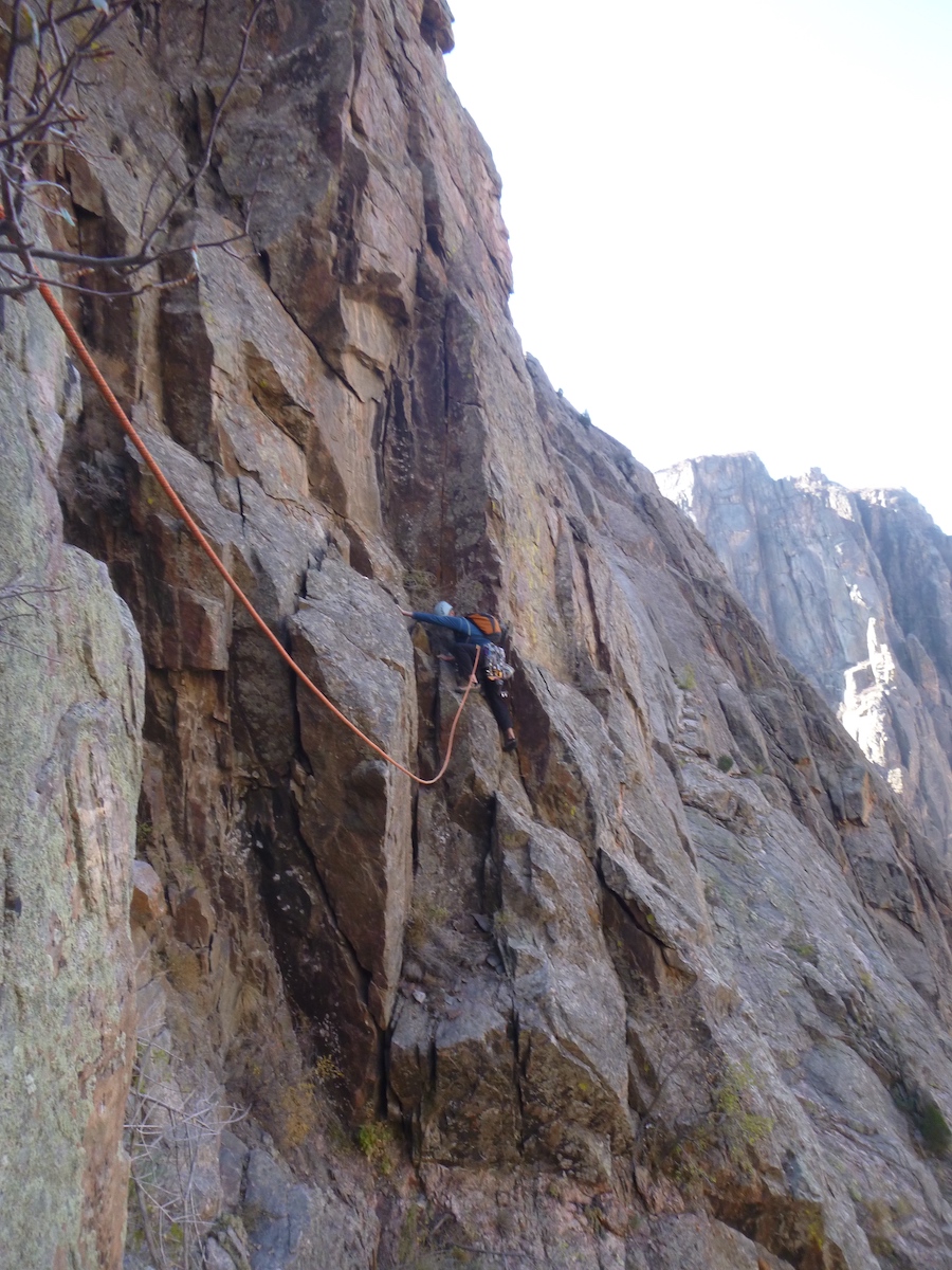 Morgan Williams steps up to the challenge on the second pitch of Power Lounger in the Black Canyon. The crack above Williams was sharp, steeper than it looked, and all the more fun with the the Black Diamond Crack Gloves! [Photo] Derek Franz
