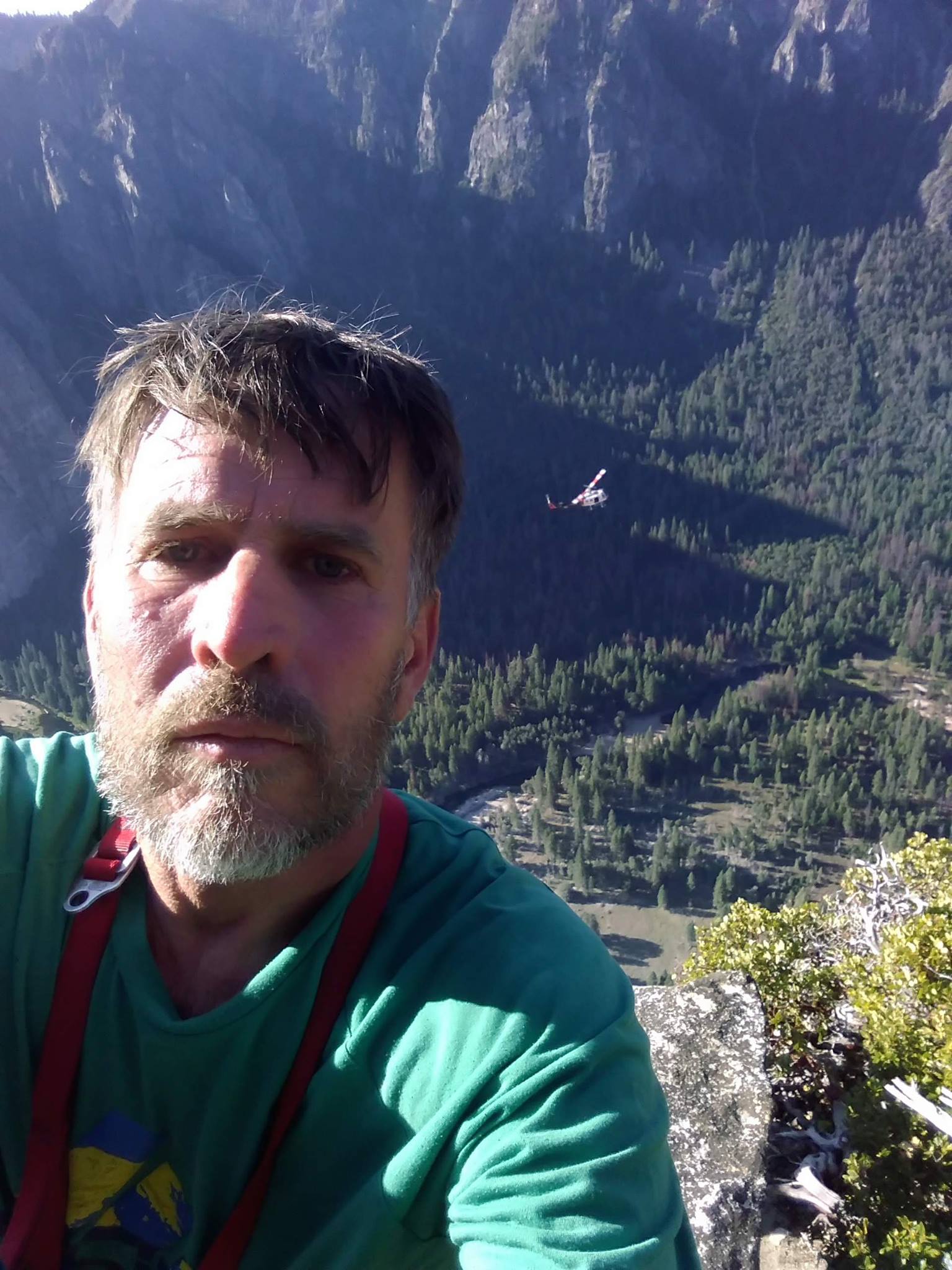 Zabrok on top of El Capitan with a Yosemite Search and Rescue helicopter flying below. [Photo] Peter Zabrok