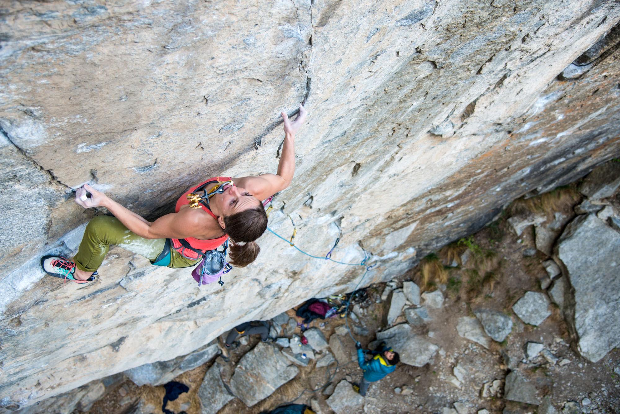 Barbara Zangerl carries a cam in her mouth to save energy for placing it during her greenpoint bid of Switzerland's Gondo Crack (5.14b R). The route was bolted 15 years ago and remained unclimbed until the end of March when Zangerl and her partner, Jacopo Larcher, did the first ascents using the bolts. In early April the two then sent the route using removable protection, skipping the bolts and risking huge falls from the crux. [Photo] Richard Felderer