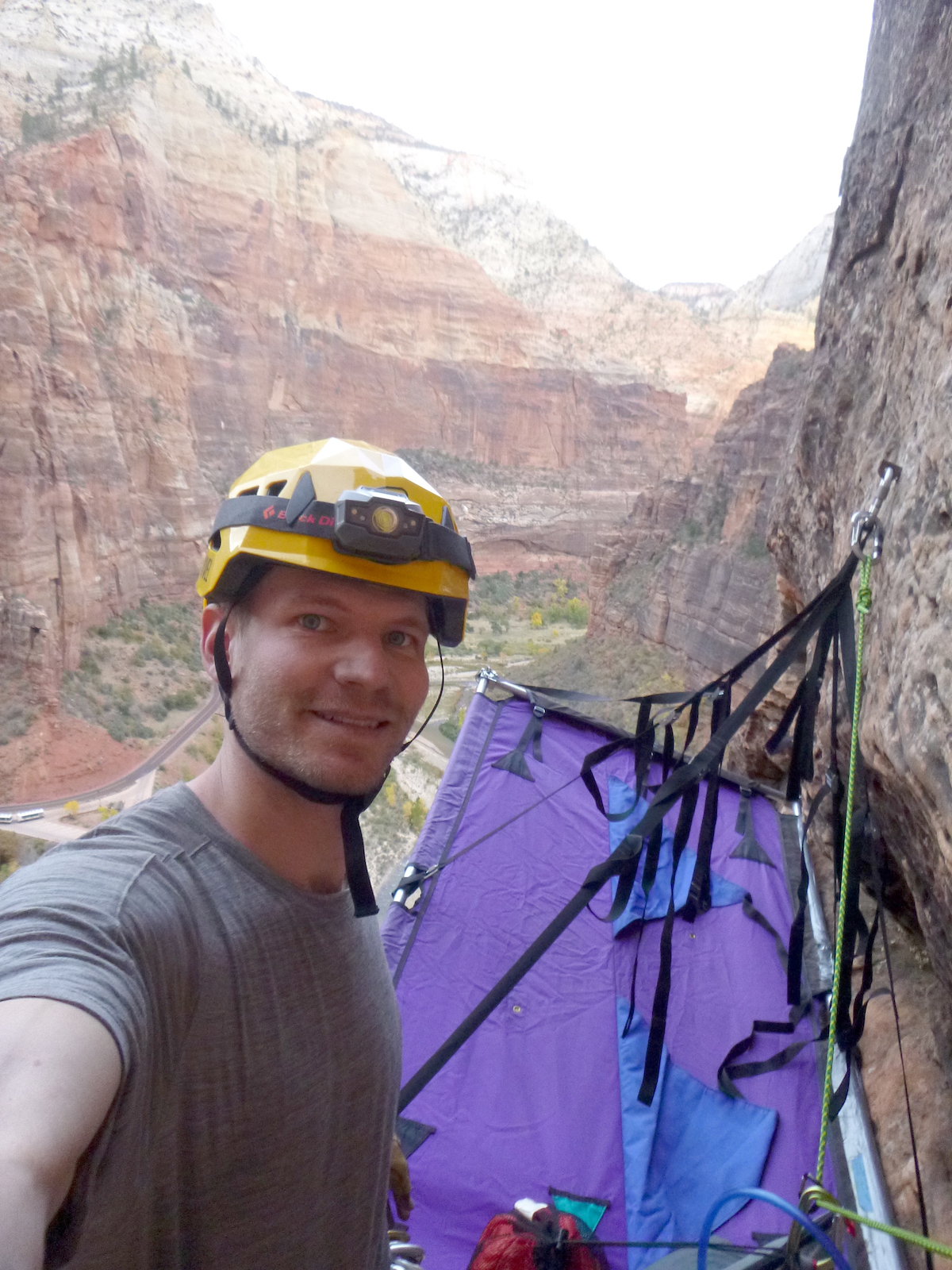 The author setting up camp and preparing to lead and fix one more pitch on the first evening of his aid-solo ascent of Prodigal Sun. Note the slack in the helmet's forward straps above his chin--a result of the chin-strap's fixed position. [Photo] Derek Franz