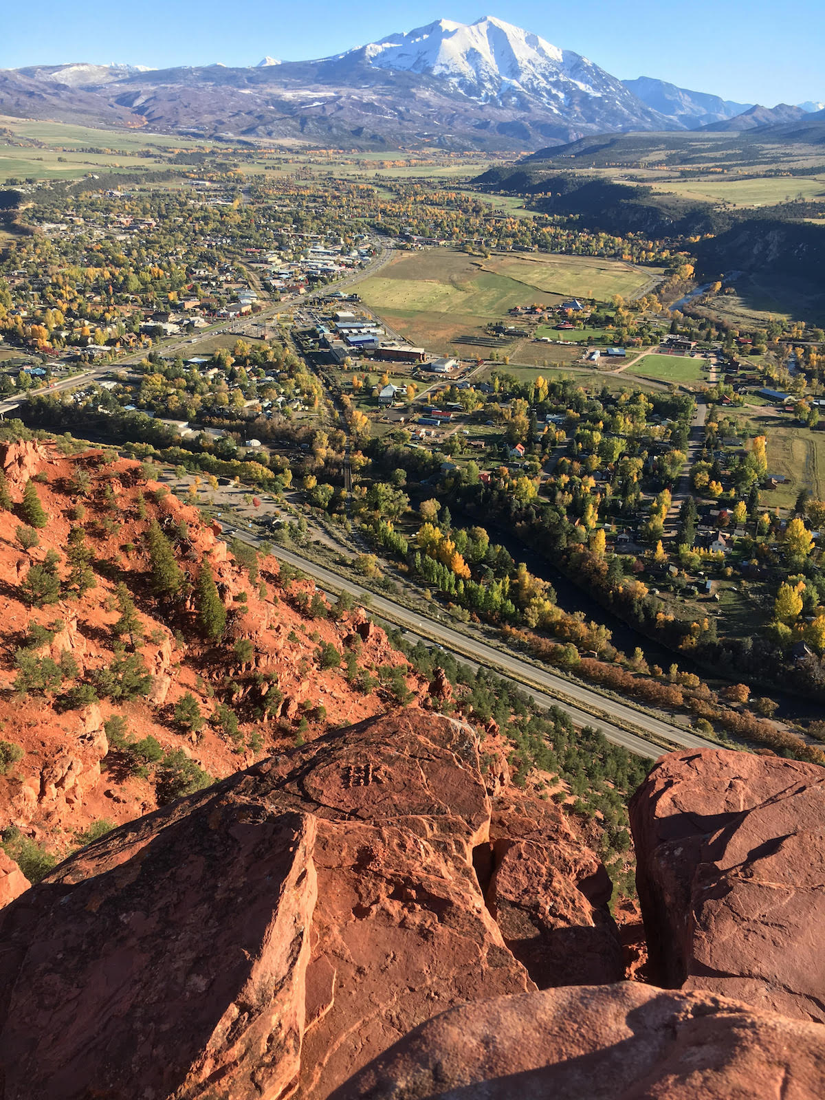 Kennedy's hometown of Carbondale, Colorado, with Mt. Sopris (12,966') in the background. The author hiked to the overlook after learning of his friends' deaths, and took several photos before noticing that someone had formed the initials HK with lines of pebbles on the rock below him, which he only saw because the angle of the sun was just right to cast shadows on the letters. It was comforting to be alone but not feel alone just then, Franz wrote. Hayden and Inge touched so many lives all around the world. It's staggering to consider the holes they left behind. [Photo] Derek Franz