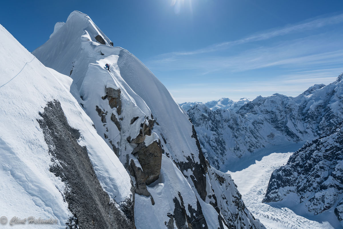 Roskelley tiptoes on steep cornices before down climbing a vertical snow section on Day 2. [Photo] Clint Helander