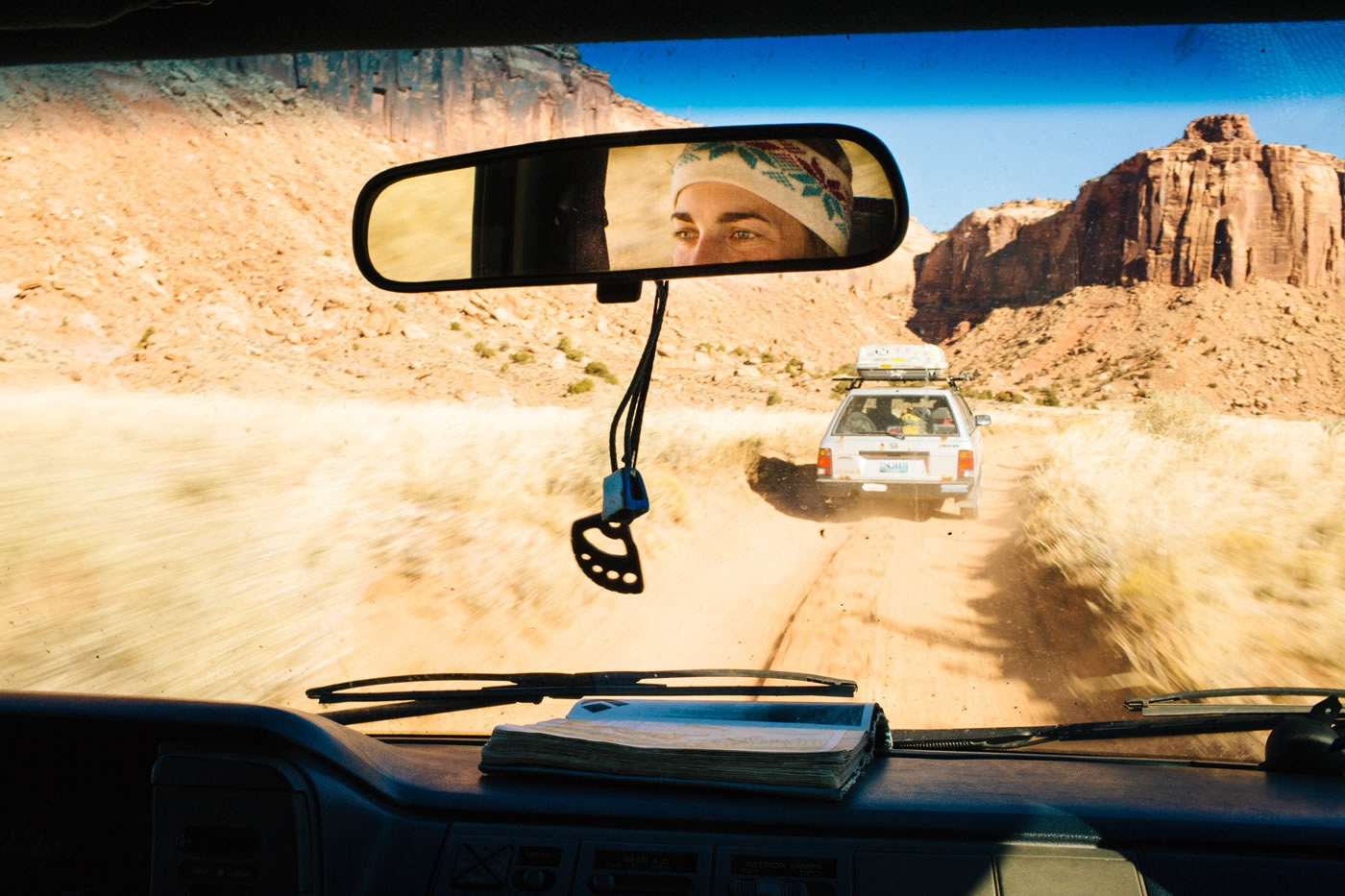 Mike jumps out of his 1992 Subaru Loyale to open the cattle gate marking the entrance to the dirt road; we slip in and let the minivan full of friends behind us latch it closed. Our ragtag caravan rallies toward Broken Tooth Wall, a cloud of dust marking our bumpy path. The guidebook lies open on the dash, red dirt bookmarking our objectives for the day, and later, our stories shared around the evening campfire. [Photo] Forest Woodward @forestwoodward @jabegg @hollandmike