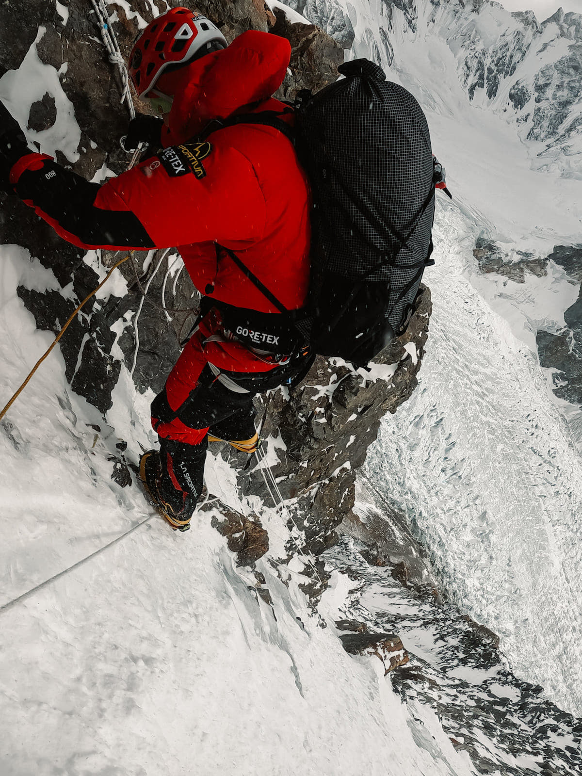 On January 4, at around 6000 meters, Lunger down climbs a steep section of the route shortly after starting to descend from Camp 1 because of high winds and worsening weather. [Photo] Alex Gavan