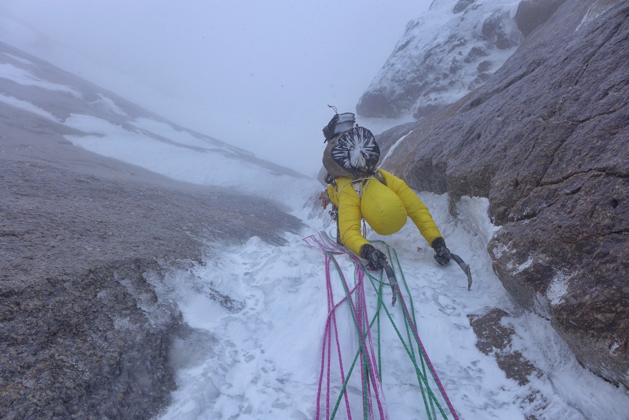 Papert climbs through a storm that rolled in as she and Lindic neared the top of the route. [Photo] Luka Lindic
