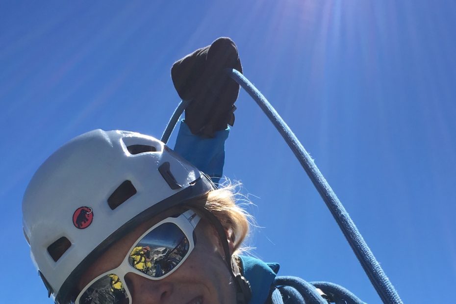 Erin Smart on the summit of la Meije in 2016, with the Pic Central in the background. [Photo] Kurt Dienel