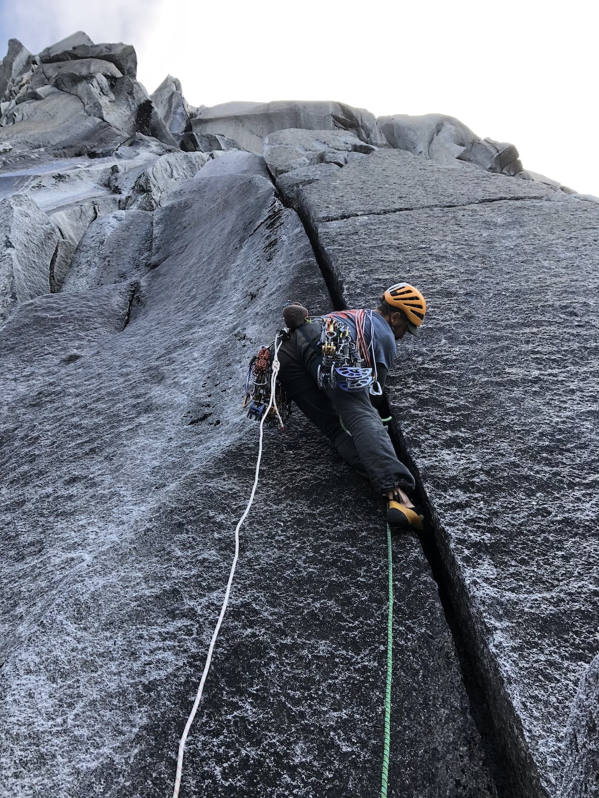 Chip Powell relishing the clean wide hand crack that marked the start of the headwall. [Photo] Chris Kalman