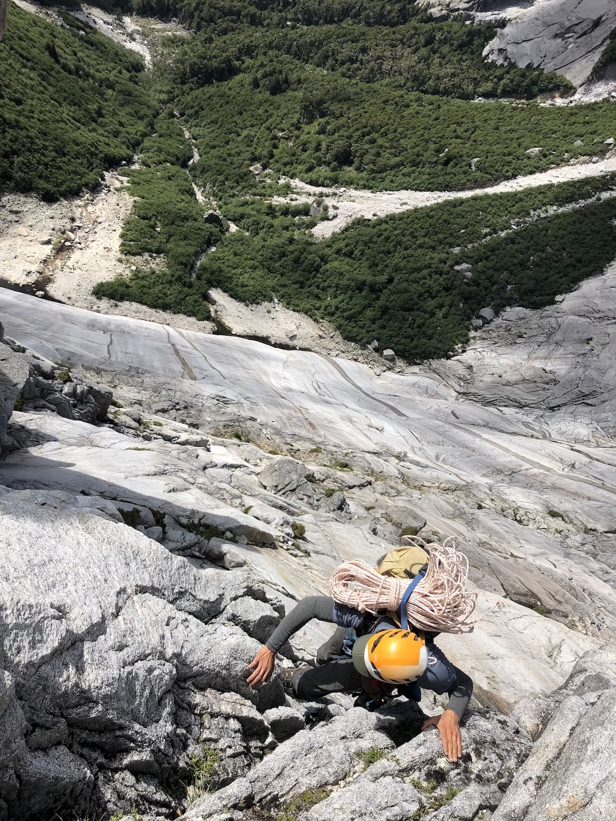Powell climbing 4th/5th-class terrain above the lower aprons of Cerro Escudo on our way to the base of the Walwalun headwall. The levity and rigidity of the Maxim PER made it an ideal candidate for strapping to the top of the pack. [Photo] Chris Kalman