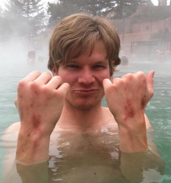 The author in 2012, nursing his wounds in the hot springs after thrashing up a desert crack without tape gloves. [Photo] Betty Prout