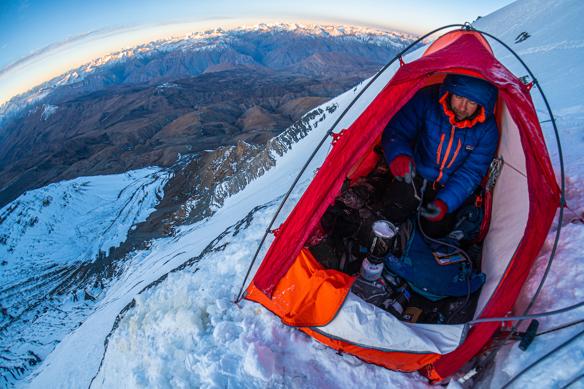 The Petzl Quarks excelled at chopping ice, which is essential for creating platforms and gathering ice to melt for water. Joel Kauffman is pictured here manning the stove on a well-chopped ledge on the route Youth 'n Asia on the southeast face of Chau Chau Kang Nilda (6303m), Himachal Pradesh, India. [Photo] Tad McCrea