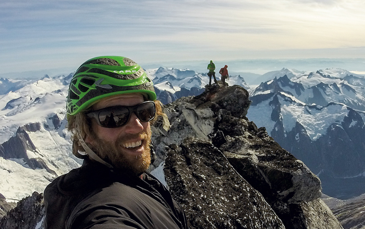Taylor on the summit with Mike and Tyler. As Klose told Alpinist, it was the first time that two parties shared the summit. [Photo] Cole Taylor