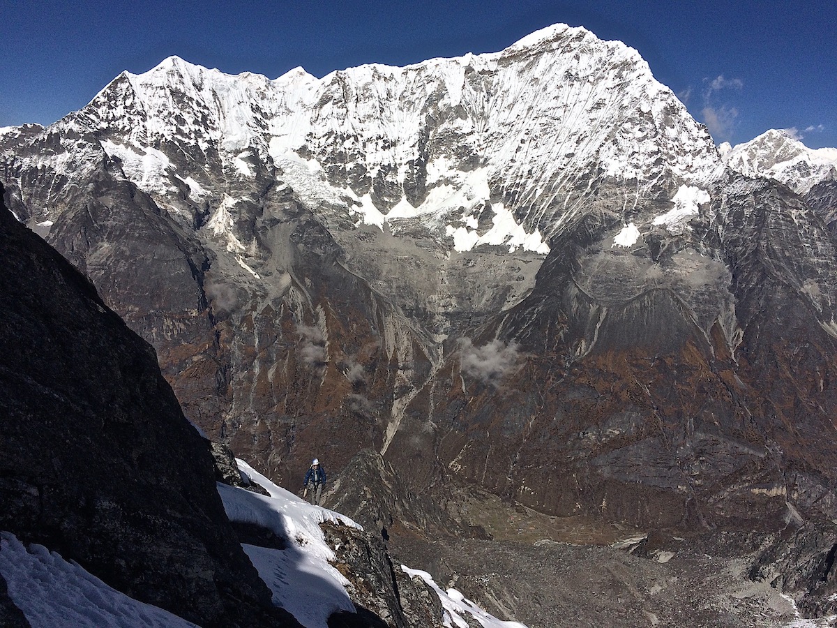 Mirhashemi nears the summit ridge of Norbu Peak (5634m) on what was potentially a new route that they called Wrong Way Bud (5.6 M4, 500m). Kang Nachugo (6737m) is in the background. [Photo] Mark Pugliese