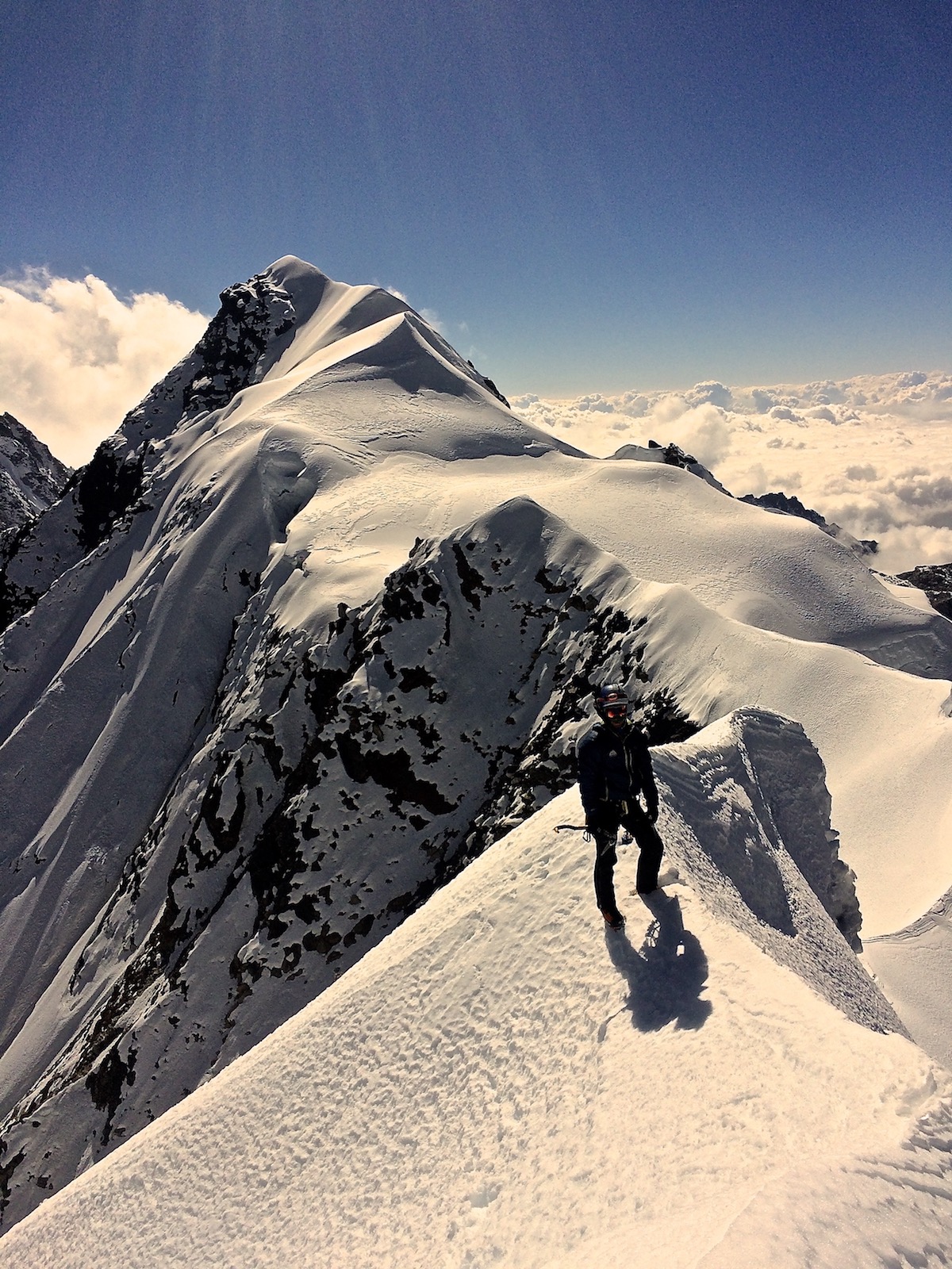 Mirhashemi climbs the summit ridge of Chugimago North (5945m) on what is potentially a new route, Witness the Sickness (M4 AI4, 75 degrees, 500m). They had to descend 100 meters shy of the summit because of snow conditions. The true (south) summit is in the background. [Photo] Mark Pugliese