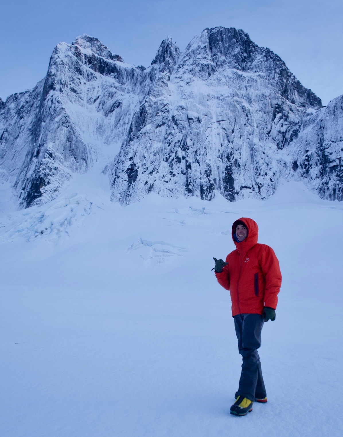 Ryan Johnson under the north face of the Main Mendenhall Tower (left) in 2015. He and partner Clint Helander attempted it the next day, but were turned around by thin ice and poor rock protection. West Mendenhall Tower is on the right. [Photo] Clint Helander