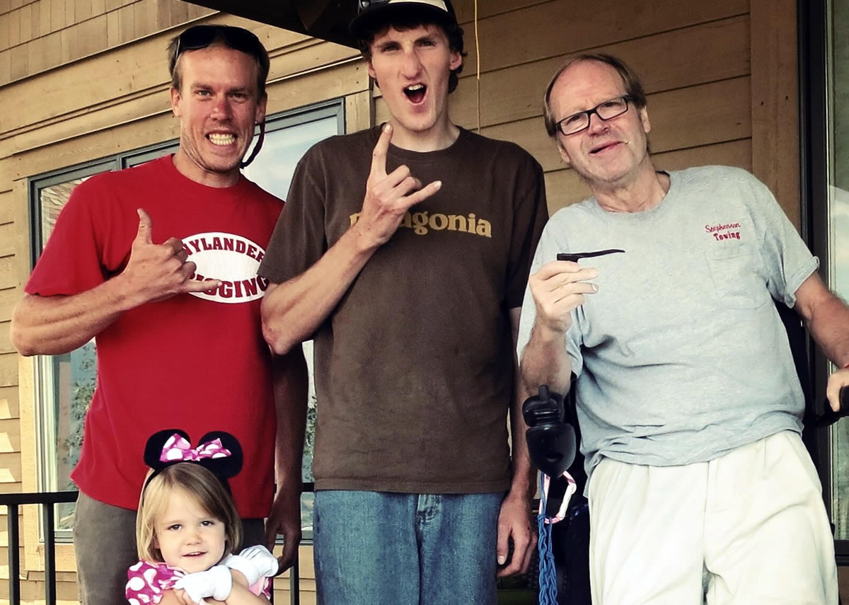 Kyle Dempster, Hayden Kennedy, Jeff Lowe and Lowe's granddaughter. In 2013 Dempster and Kennedy, along with the late Justin Griffin, established a variation to the North Tower Crack, which they called the Lowe-Spark (IV 5.13 A0, 1,200'). Here Lowe holds one of the pitons that he'd placed in 1969 and that the 2013 ascent team recovered from the original route. [Photo] Kyle Dempster.