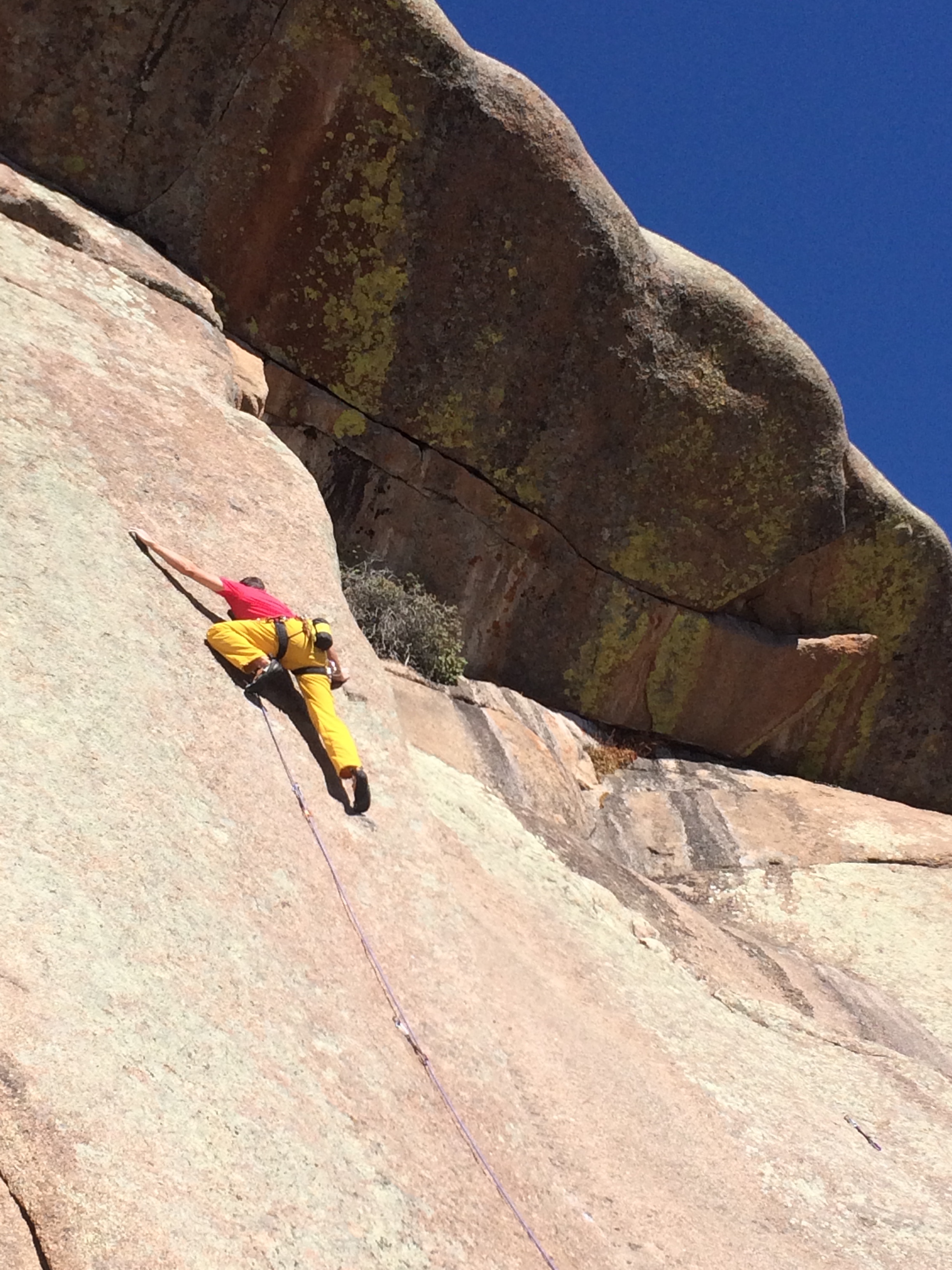 Mike Lewis delicately edges up a steep slab route called Sport (5.10d) in Vedauwoo, Wyoming. [Photo] Lodi Siefer