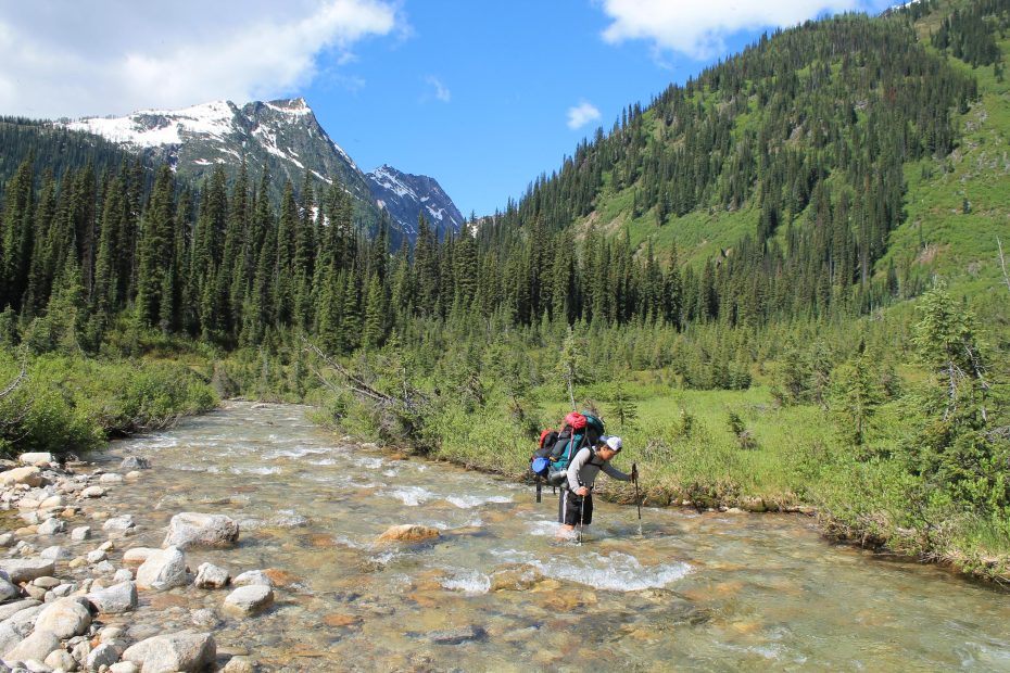 Paul Bonnell crosses Dewar Creek on the approach to The Leaning Towers, Purcell Wilderness, British Columbia. [Photo] Aaron Hanson