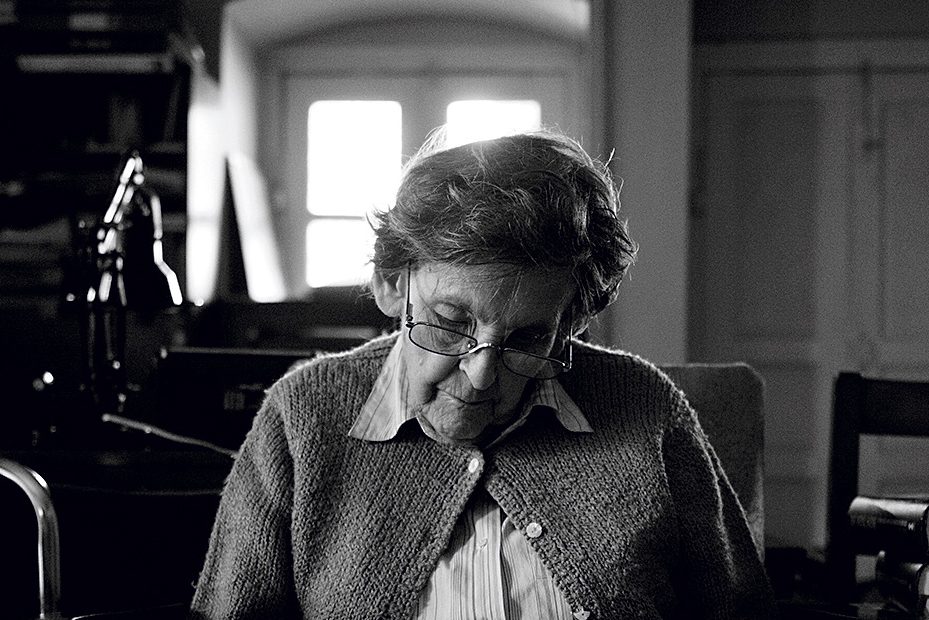 The great Himalayan chronicler Elizabeth Hawley paging through files at her apartment in Dilli Bazar, Nepal, after the 2015 earthquake. [Photo] Alet Pretorius