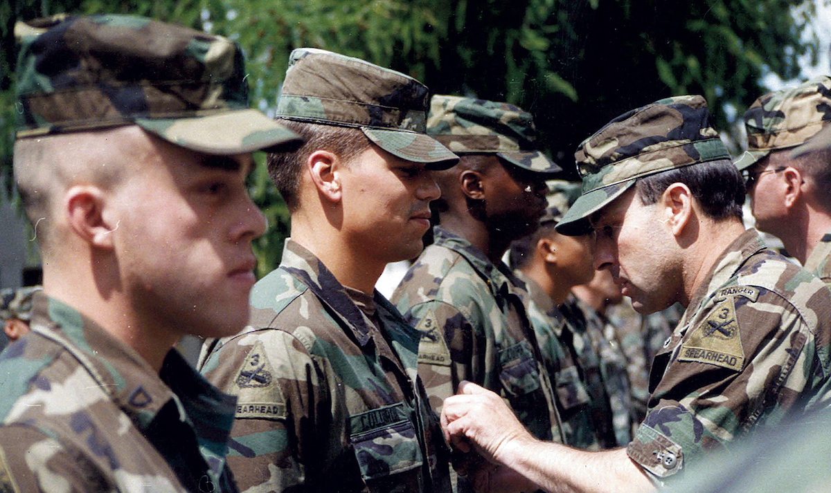 Coldiron receives his Combat Infantryman Badge from Lieutenant Colonel Michael Deegan in 1991. Hans Moldenhauer recalled the end of his pre-war climbs in the 1943 American Alpine Journal: While we anticipated the new winter...war came to our country's shores, unasked, unwanted and with cruel suddenness...The dangers which we undergo in climbing, we take voluntarily. But war is must, and must is always hard. [Photo] Courtesy Scott Coldiron