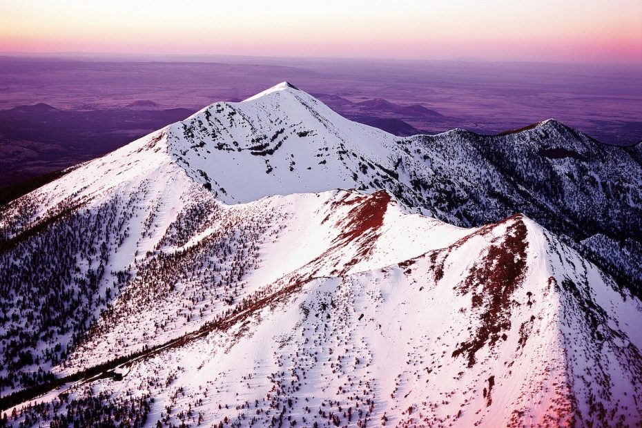 Pictured here at sunset, Dook'o'oosliid, or Humphreys Peak (12,633'), is the highest point in Arizona. Dook'o'oosliid was once part of a much larger stratovolcano that erupted hundreds of thousands of years ago. [Photo] Chuck Lawsen
