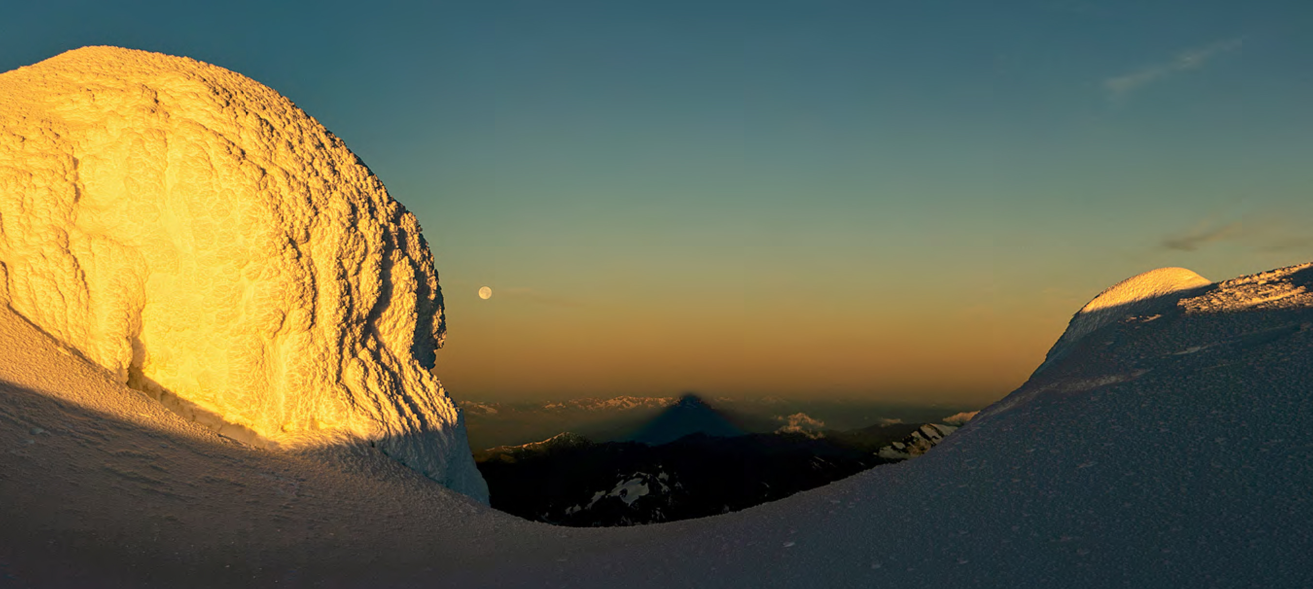 Looking west to the mountain's shadow cast by the rising sun behind. [Photo] Uisdean Hawthorn