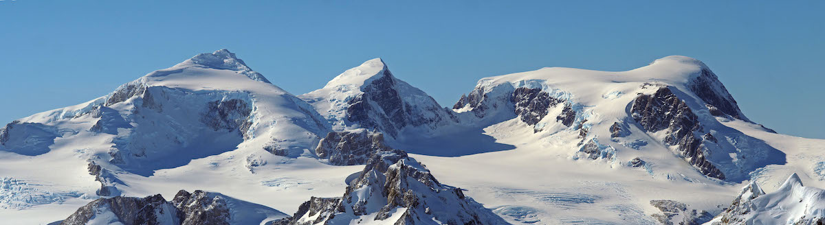Image 1 of 2: This photo and the one below originally appeared as a panorama across two pages in Alpinist 75; it has been split into two frames to allow for better viewing on the webpage. It shows the view from Mt. Ilse (2506m), during its first ascent by Natalia Martinez and Camilo Rada in April 2021, in the Southern Patagonian Ice Field. Mt. Ilse is named for Ilse von Rentzell, who roamed the area in 1933. Only one of the summits in this photo has been climbed, Martinez says. [Photo] Camilo Rada/UNCHARTED project