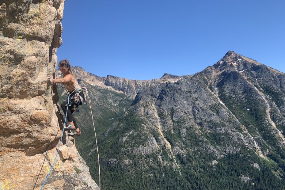 Whitney Clark traversing out from one of the supercaves while climbing The Tiger on Washington Pass with the Beal Opera rope. [Photo] Will Stanhope