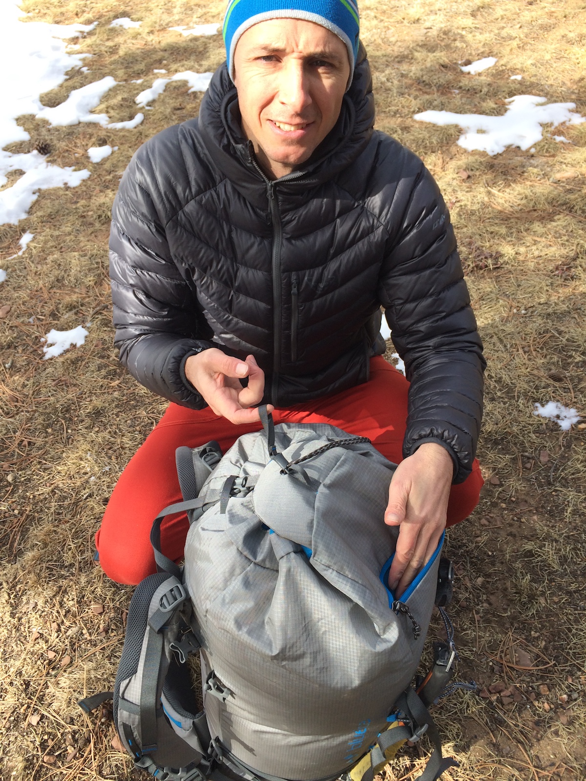 The author shows the releasable skirt on top of the pack body and the zippered front pocket. [Photo] Chris Wood