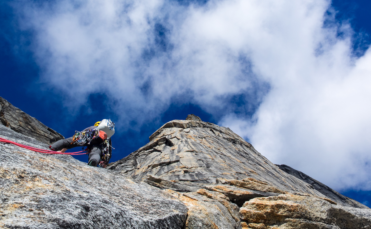 Leading on unexplored terrain on the east face of Caliban in Alaska’s Arrigetch Range. Gus Barber, Lang Van Dommelen and Chris Williams’ new route, which they are simply referring to as the East Face for now, is a 2,500-foot Grade IV+ 5.11. [Photo] Lang Van Dommelen