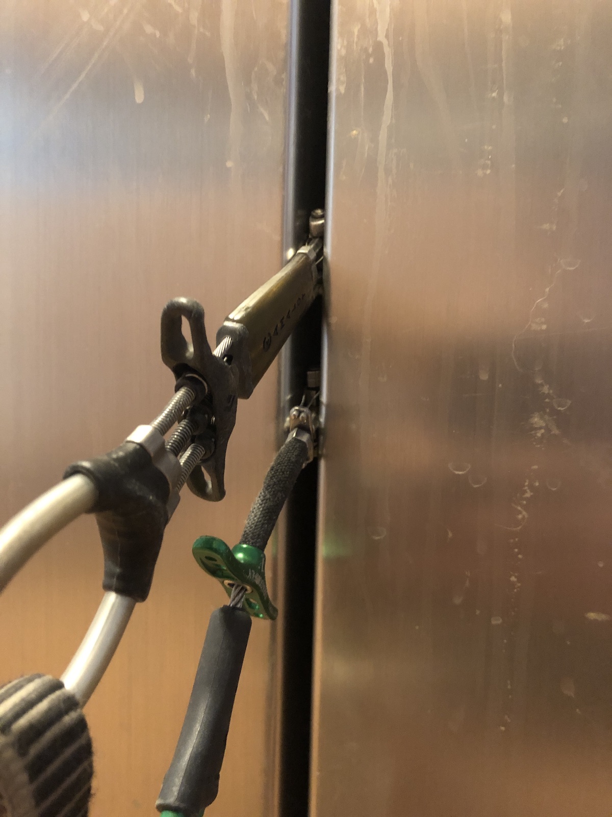 This photo shows how the smallest DMM Dragonfly (the green unit on the bottom) compares to the smallest Black Diamond C3 compare when placed in between the doors of the author's refrigerator. [Photo] Chris Kalman