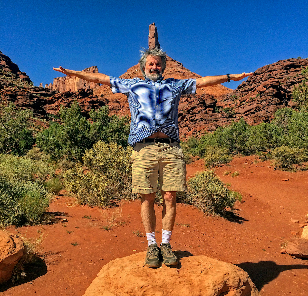 Ed Webster spreads his wings with Castleton Tower and the Rectory in the background, Utah, 2018. [Photo] Stewart M. Green