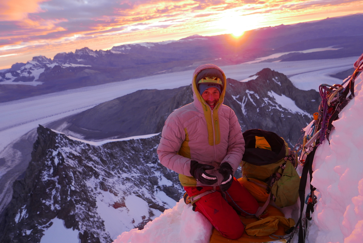 Bordella enjoys the first rays of sun after a cold bivy in the snow. [Photo] Matteo Bernasconi
