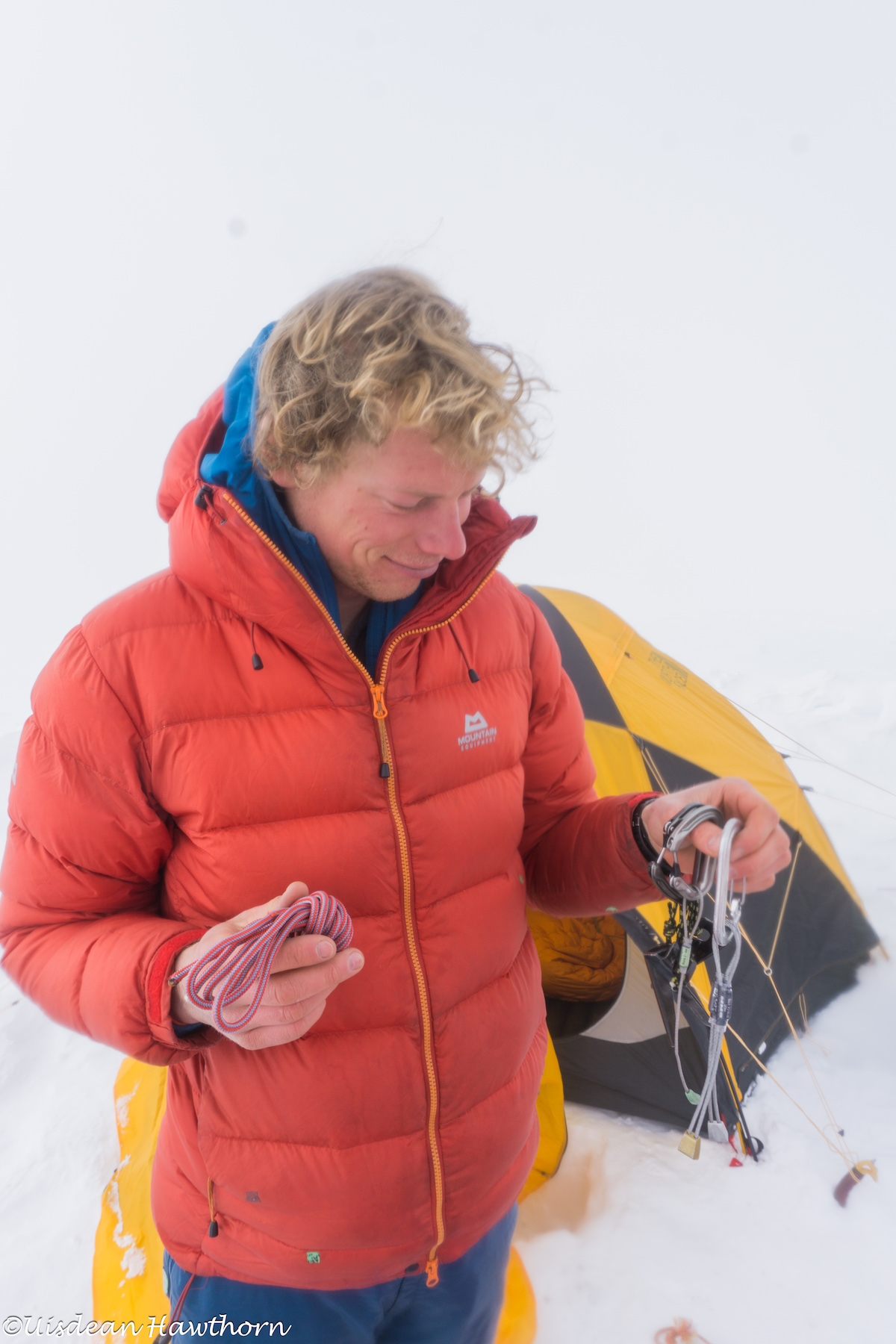 Livingstone contemplates the remainder of his rack after rappelling from their high point on the north face. [Photo] Uisdean Hawthorn