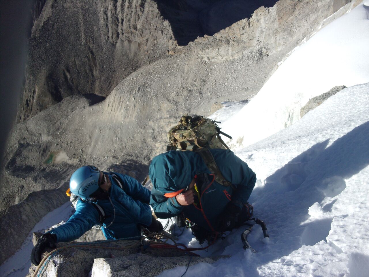 Looking down on Mitch Murray and Rob Baker at the final anchor around 5610 meters, with advance base camp just visible at the lake 700 meters below. [Photo] Ed Hannam