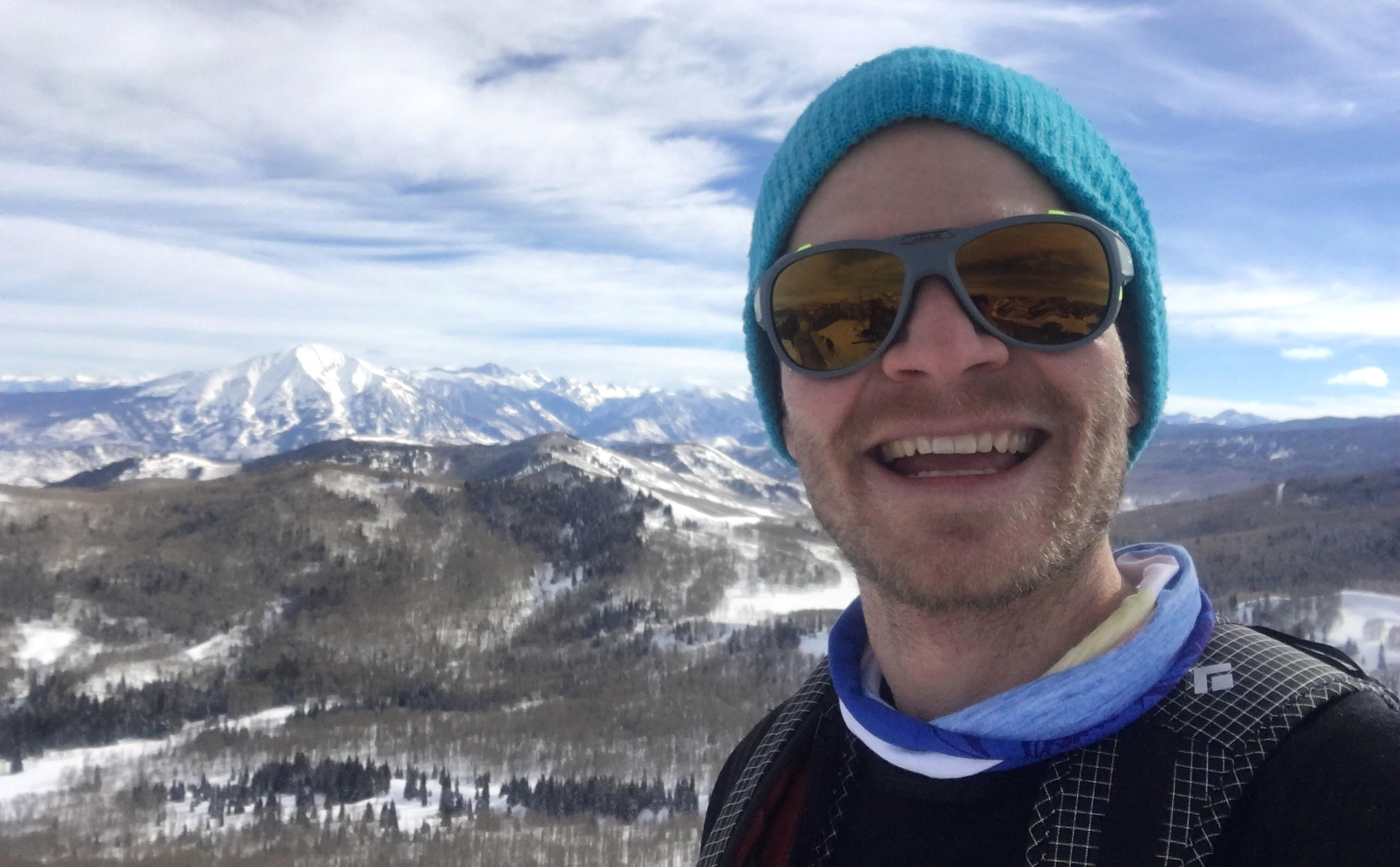 The author enjoys the Julbo Explorer 2.0 sunglasses on a backcountry ski run in Colorado. Mt. Sopris (12,966'), left, Capitol Peak (14,131') and other summits in the famous Elk Range are visible in the background. [Photo] Derek Franz