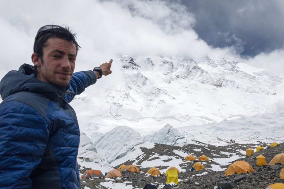 Kilian Jornet points to Mt. Everest's shrouded summit while acclimatizing for his first speed ascent of the North Col route. [Photo] Sebastien Montaz-Rosset/Kilian Jornet collection