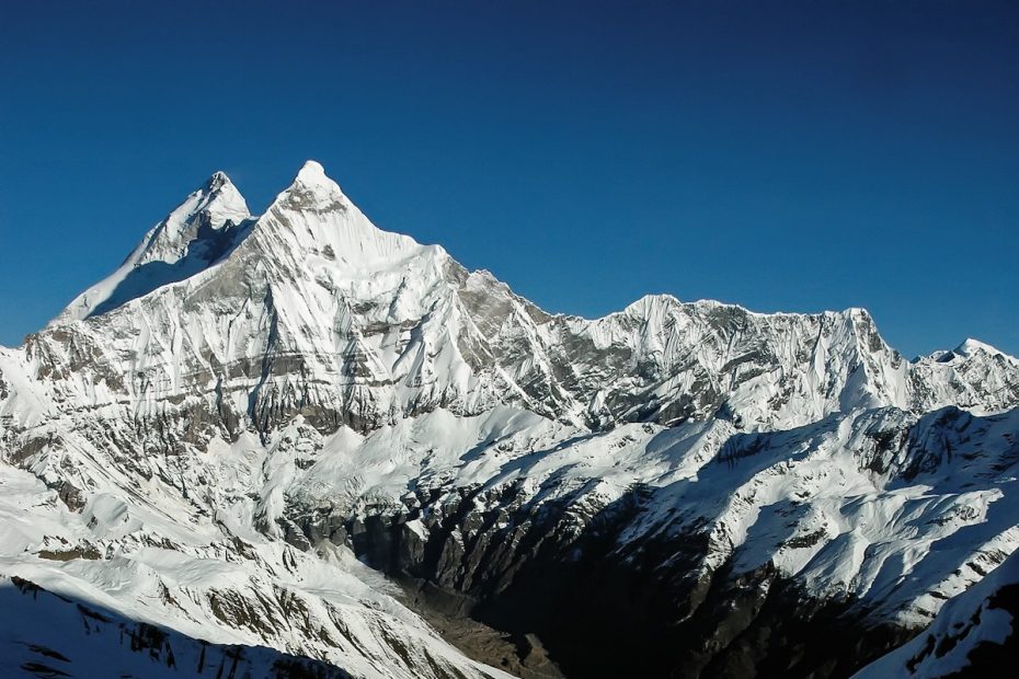 Pete Takeda is pictured here on a 2005 expedition to Nanda Kot with the east face of Nanda Devi East / Sunanda Devi in the background, which is just in front of the main peak of Nanda Devi in the Indian Himalaya. Takeda authored a two-part Mountain Profile about the area in Alpinist issues 62 and 63 (Summer and Autumn 2018). [Photo] Pete Takeda collection