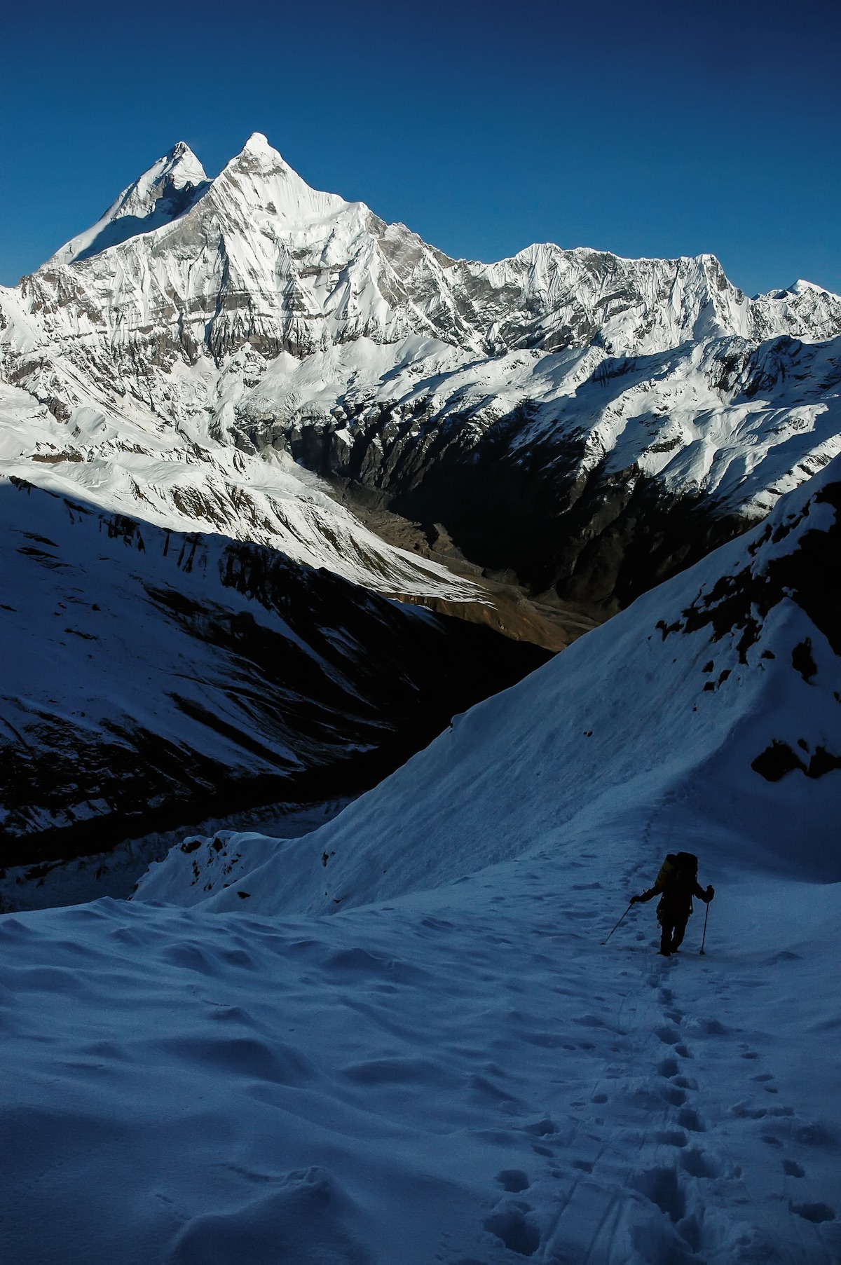 Pete Takeda is pictured here on a 2005 expedition to Nanda Kot with the east face of Nanda Devi East / Sunanda Devi in the background, which is just in front of the main peak of Nanda Devi in the Indian Himalaya. Takeda authored a two-part Mountain Profile about the area in Alpinist issues 62 and 63 (Summer and Autumn 2018). [Photo] Pete Takeda collection