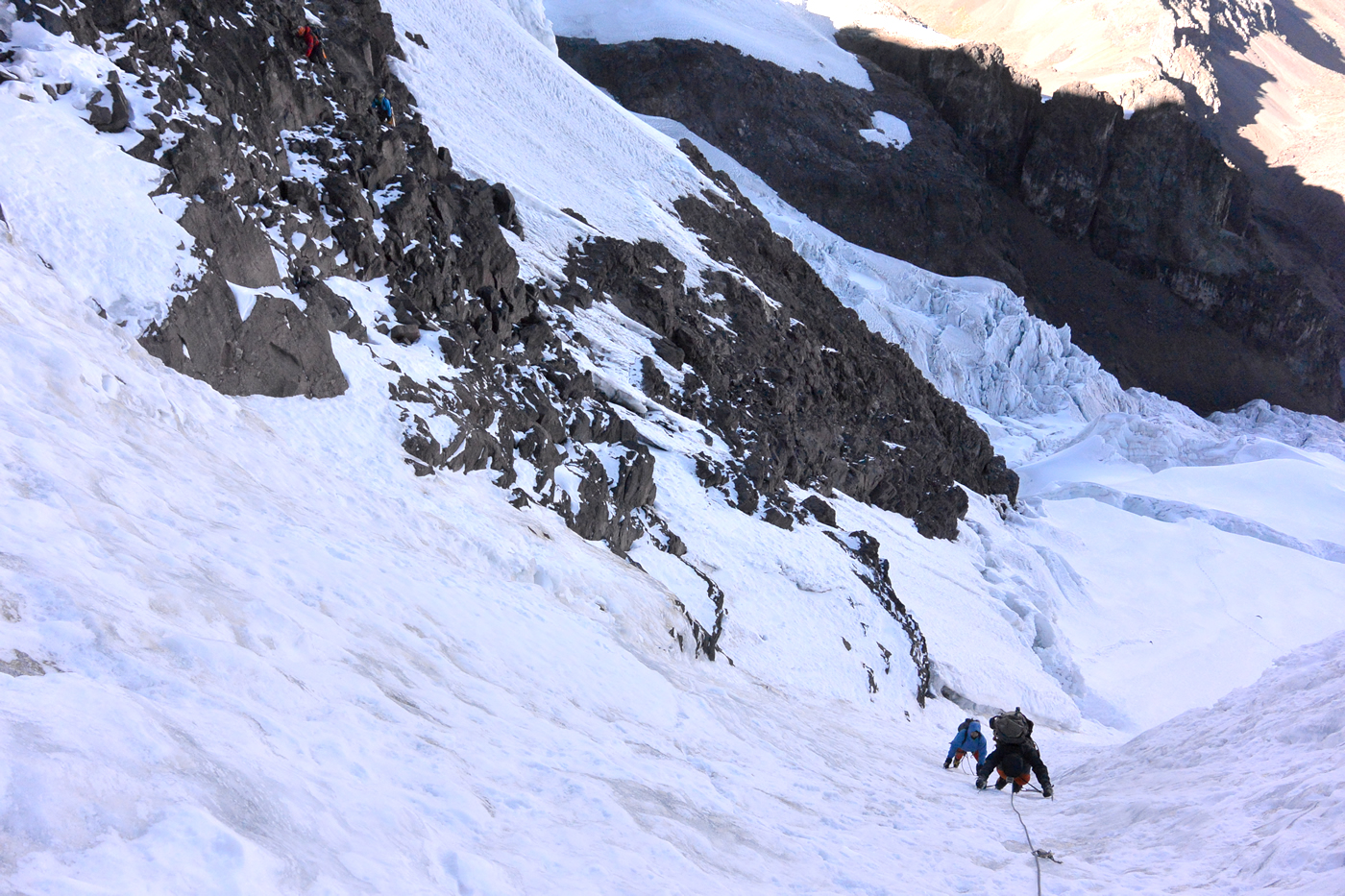 Field and Zimmerman ascend the snow and ice runnels en route to the south/southeast ridge of Allincapac, while McDaniel and Beltrami opt for the rock line beside them. [Photo] Nathan Heald