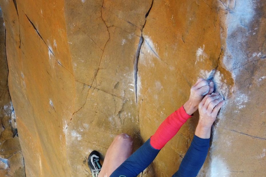 Lor Sabourin staring down the crux of East Coast Fist Bump (5.14a) at The Waterfall