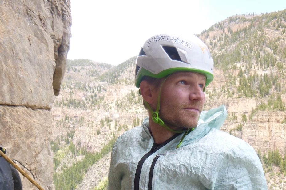 Derek Franz stays warm at a breezy belay with NW Alpine's Eyebright jacket atop Pitch 4 of Horse and Pony Show (III 5.11d) on the obscure Grizzly Creek Wall in Glenwood Canyon, Colorado. [Photo] Craig Helm