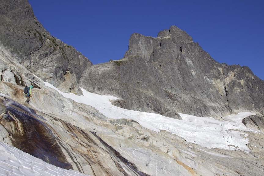 Estenson traverses beneath Mt. Triumph to climb the Northeast Ridge with the Osprey Mutant 22-liter pack. Despite its low, contoured profile, it's easy to carry a rope atop a full pack. [Photo] Mallorie Estenson collection